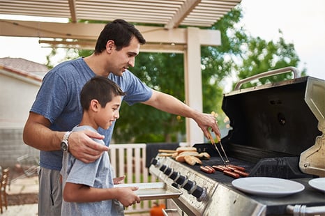 father and son grilling together