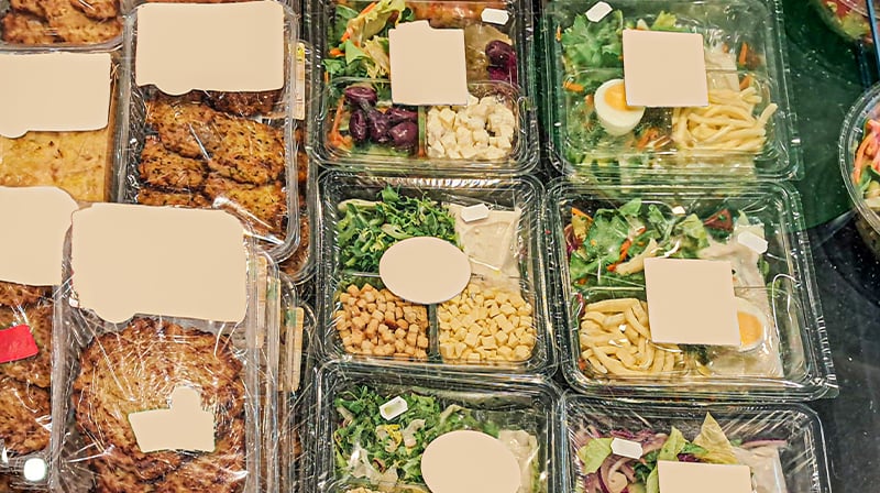 variety of prepackaged organic meals and salads displayed in the supermarket