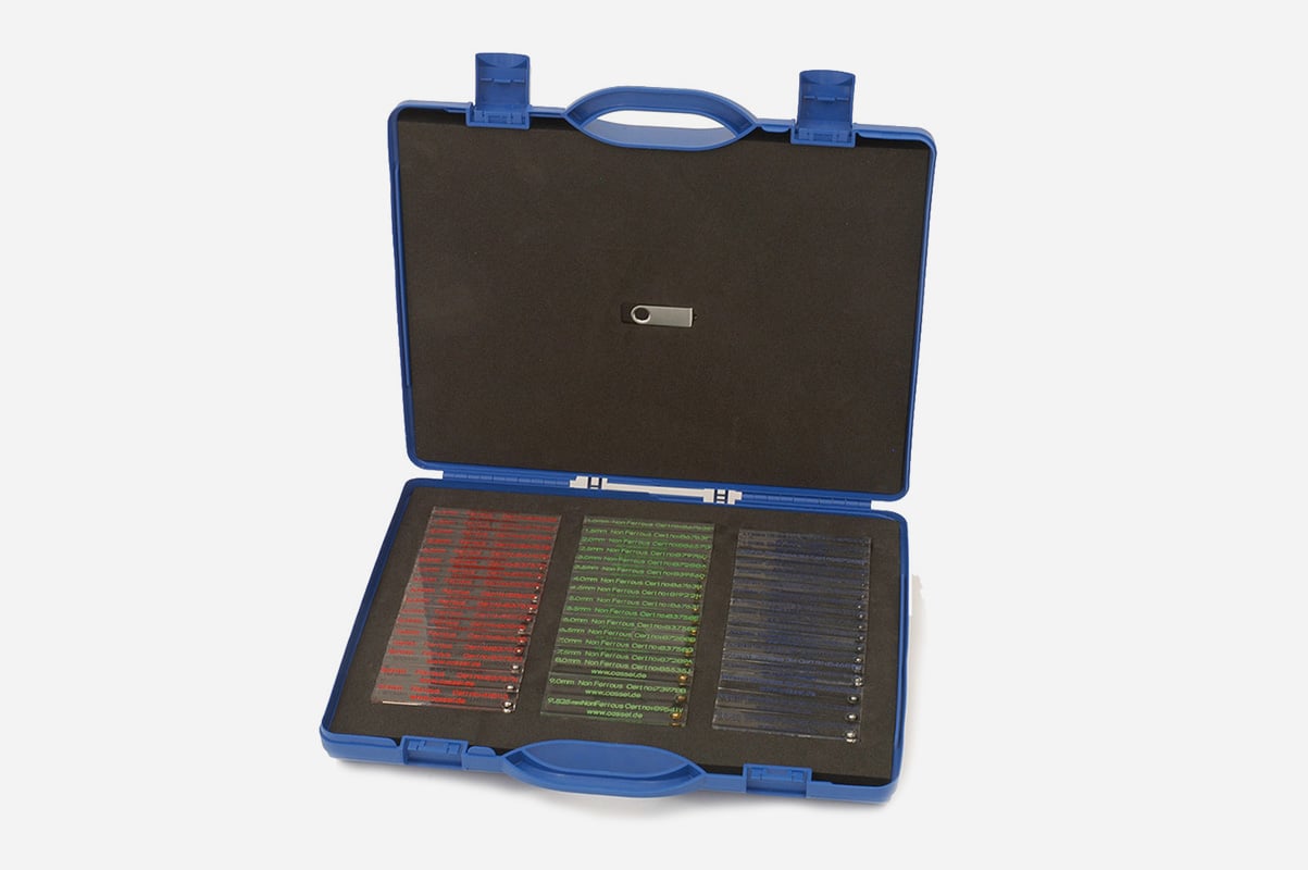 A blue, hard-plastic brief case with black sponge padding on the inside and housing three rows of colored glass testing slides.