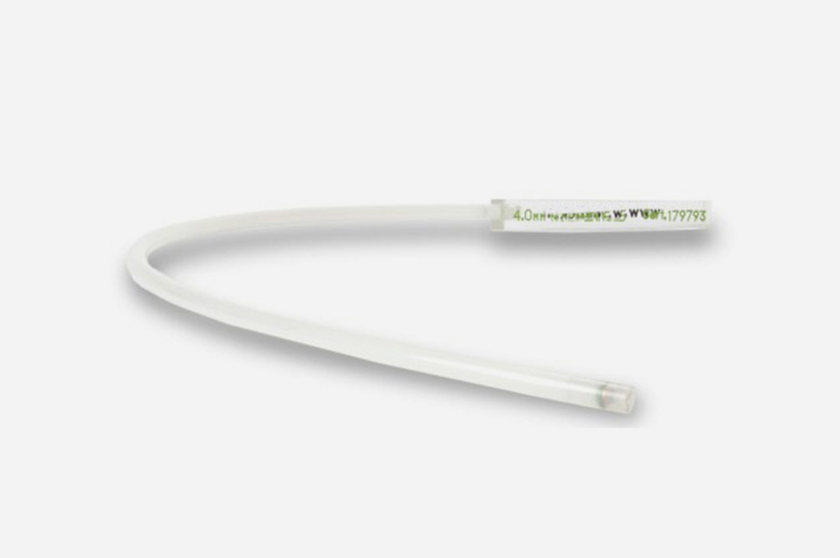 A clear white plastic hose laying on it's side in the shape of a 