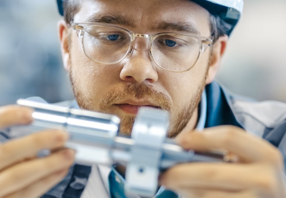 CASSEL worker examining a part on an inspection machine.