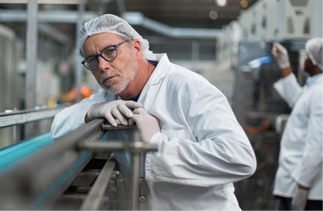 Line Operator watching the inspection machine in a factory